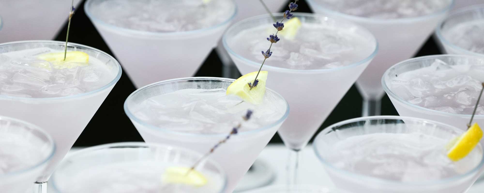 | The Cape Collection company party venue photo of rows of celebratory clear cocktails or perhaps water with lemon garnish